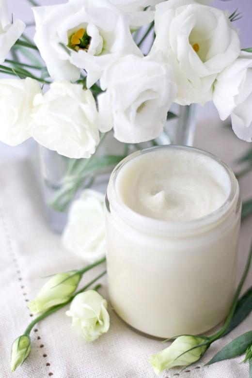 DIY cleansing balm surrounded by white flowers