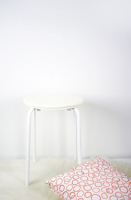 Materials for DIY fuzzy stool: IKEA stool with pillow and fuzzy faux sheepskin rug