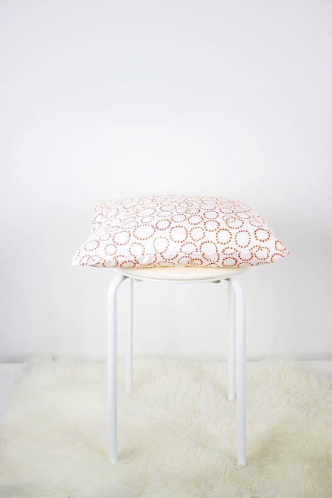 Pillow and chair pad pictured on top of stool