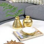 DIY gold leaf vases styled on coffee table with marble coasters and wooden pineapple