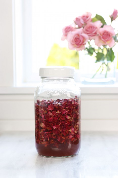 Glass jar infusing a batch of rose petal vinegar