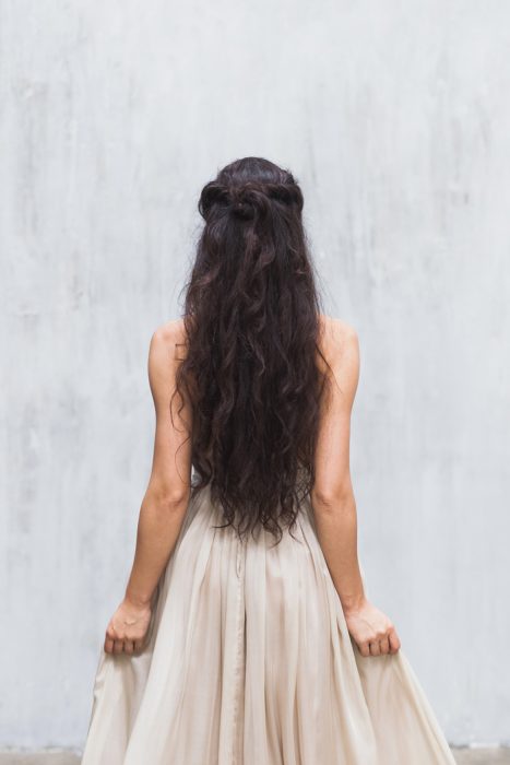 Woman in white dress with beautiful, flowing brown hair