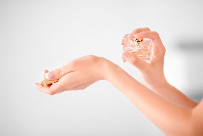 Spritzing perfume on wrists
