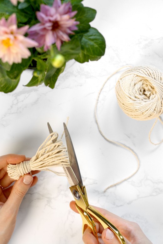 Creating a tassel for DIY wood garland – scissors cutting cotton string