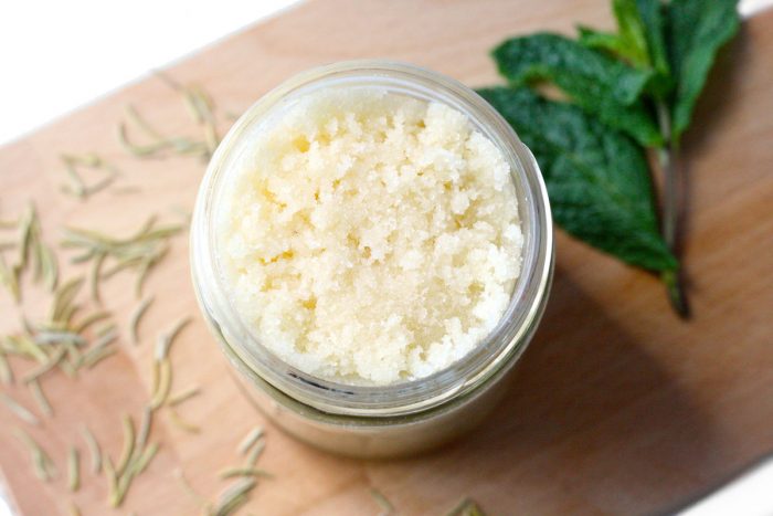 Learn how to make an easy, skin-revitalizing DIY rosemary peppermint sugar scrub with Japanese camellia oil. Rosemary and peppermint essential oils increase circulation, reduce stress, and help alleviate muscle aches and pains. Camellia oil is light, non-greasy, and nourishing to the skin. It’s also higher in quality than oils such as sunflower and sweet almond. #DIY #DIYBeauty #GreenBeauty