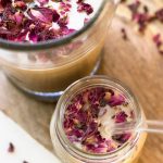 Homemade iced latte garnished with rose petals