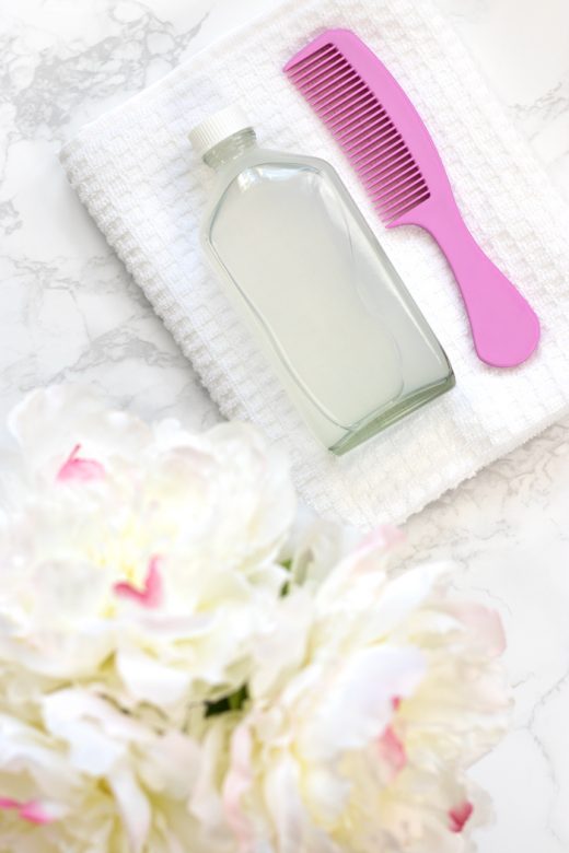 DIY micellar cleansing water for hair with pink comb
