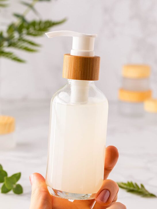 DIY cleansing oil makeup remover held in woman's hand.