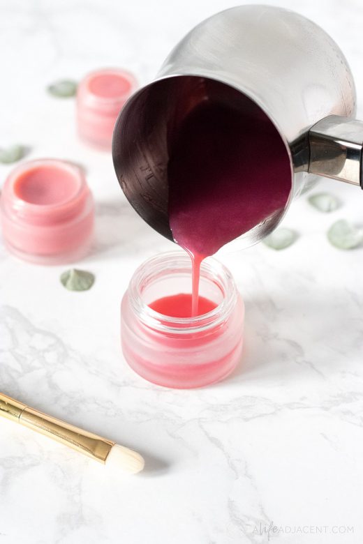 Melting homemade tinted lip balm with lipstick