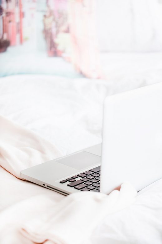 Laptop computer sitting on bed