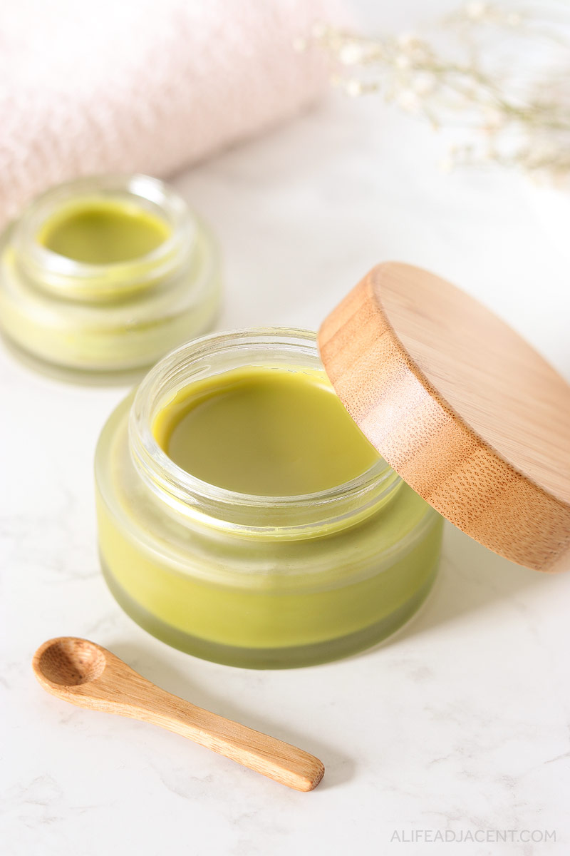 Green tea overnight mask in glass jar with bamboo spoon