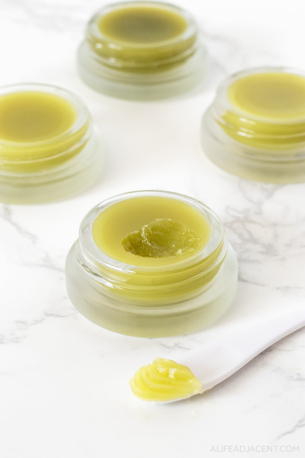 Texture shot of DIY green tea lip balm without coconut oil