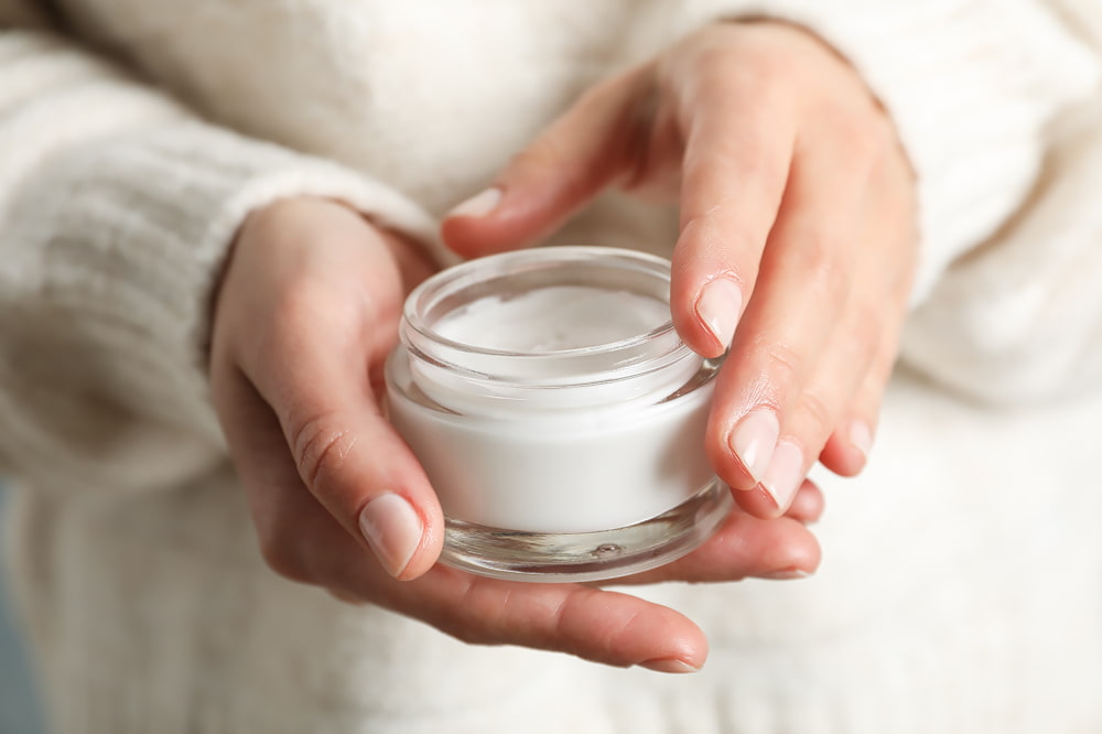 Woman's hands holding DIY magnesium body lotion