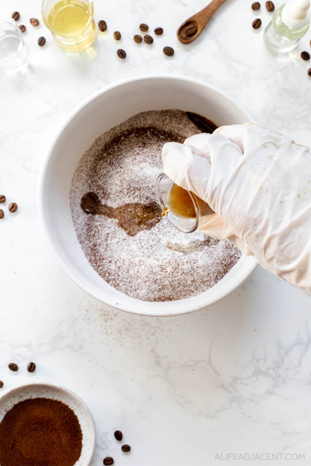 Adding ingredients to coffee bath bombs.