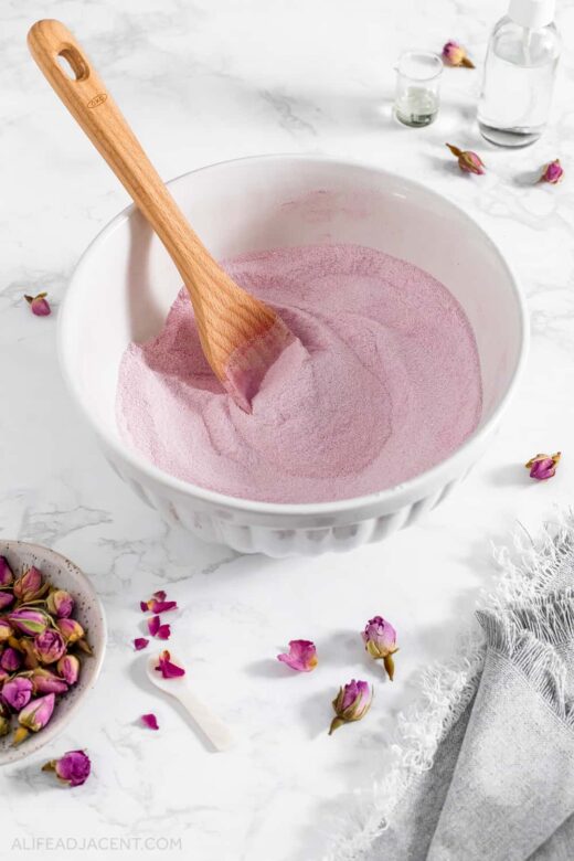 Mixing pink beet powder into pink bath bombs mixture