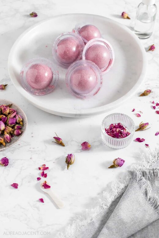 Pink rose bath truffles in molds on plate