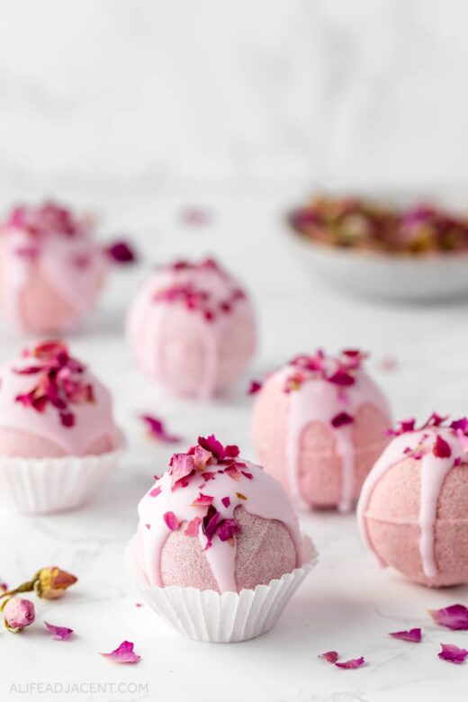 Pink cocoa butter bath truffles with rose petals.