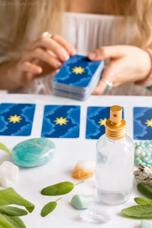 Aura spray for cleansing with crystals, sage, and Tarot cards