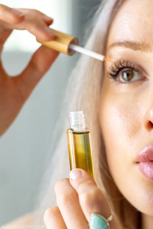 DIY eyelash serum for growth – woman applying serum to lashes