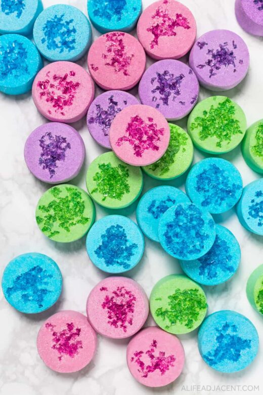 Shower steamers in blue, pink, purple, and green.