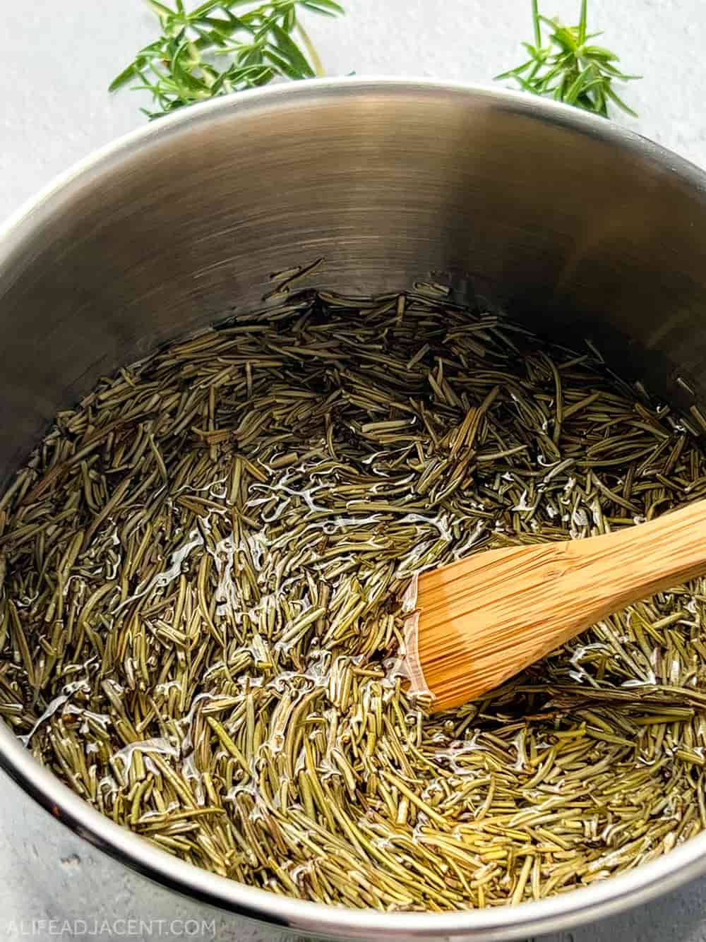 How to make rosemary oil for hair – heating oil on stovetop.