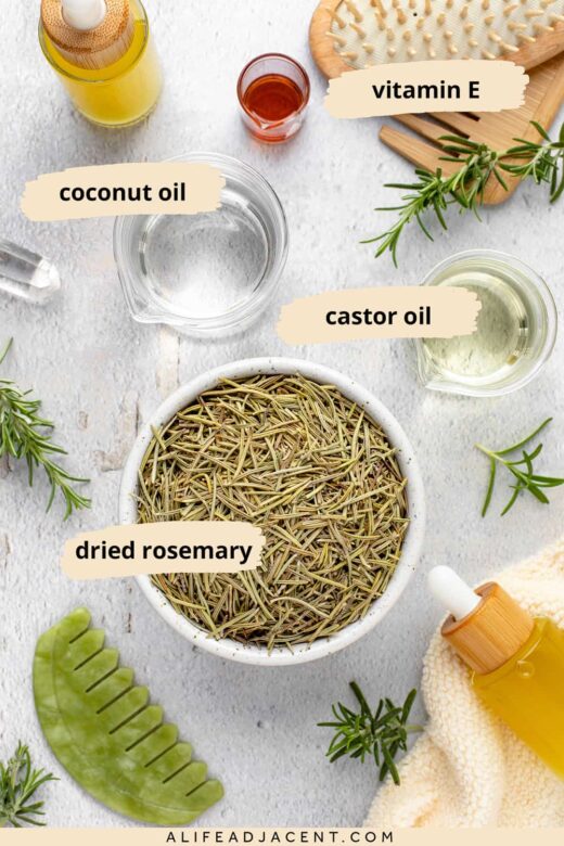 Rosemary hair oil recipe ingredients. Dried rosemary leaves, castor oil, fractionated coconut oil, and vitamin E.