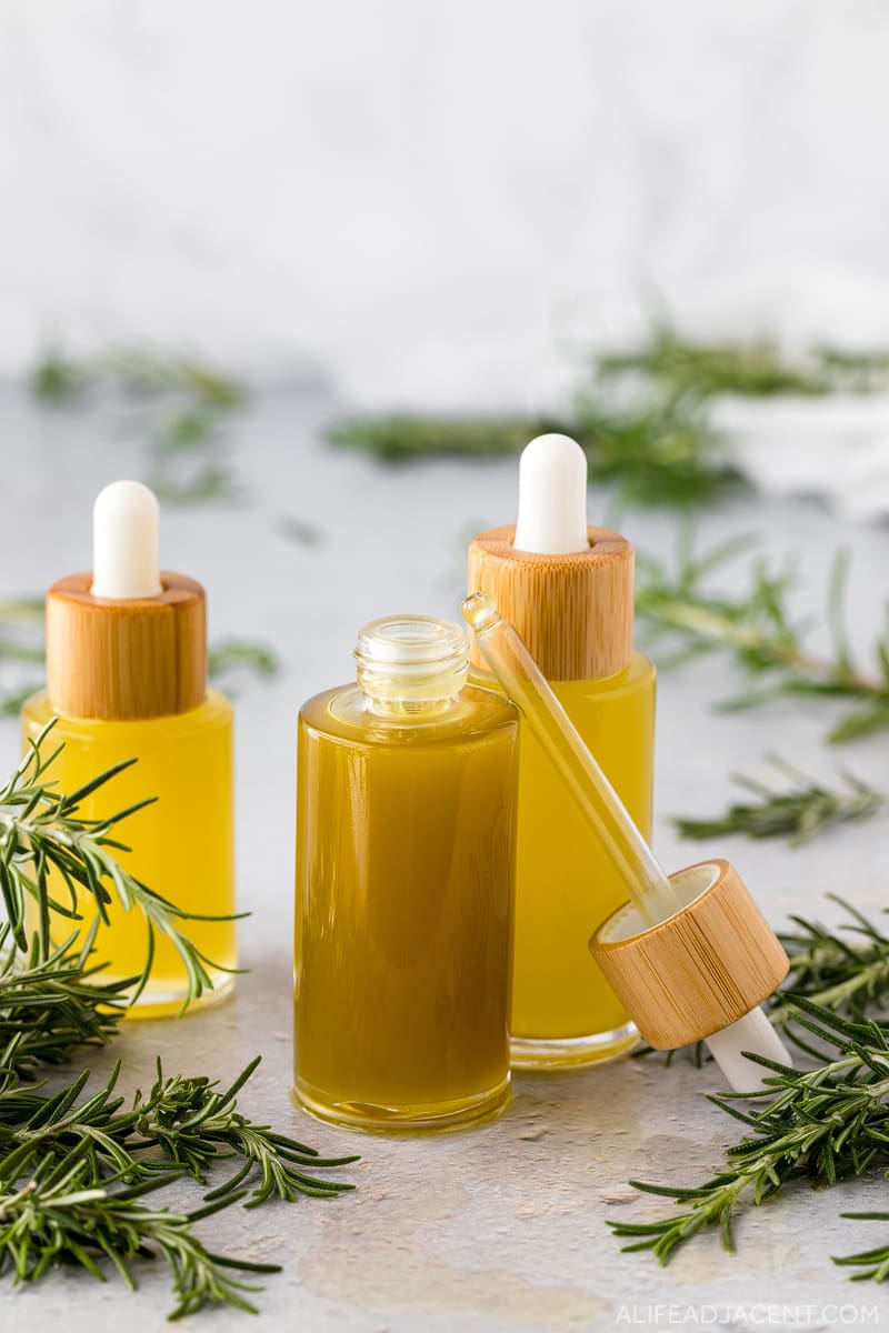 Rosemary hair oil in glass dropper bottles