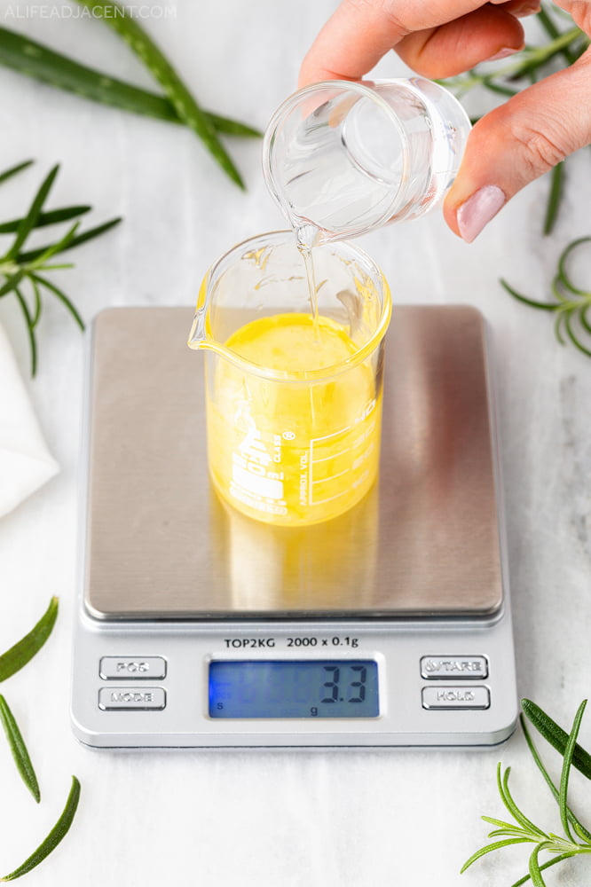 Adding water to aloe and rosemary serum mixture.