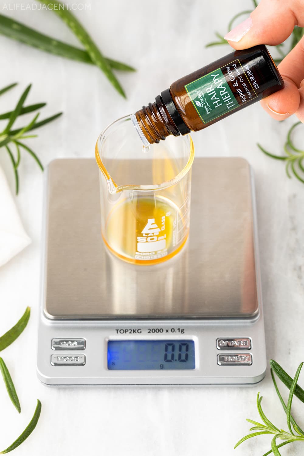 Dispensing hair growth essential oil blend to make serum.