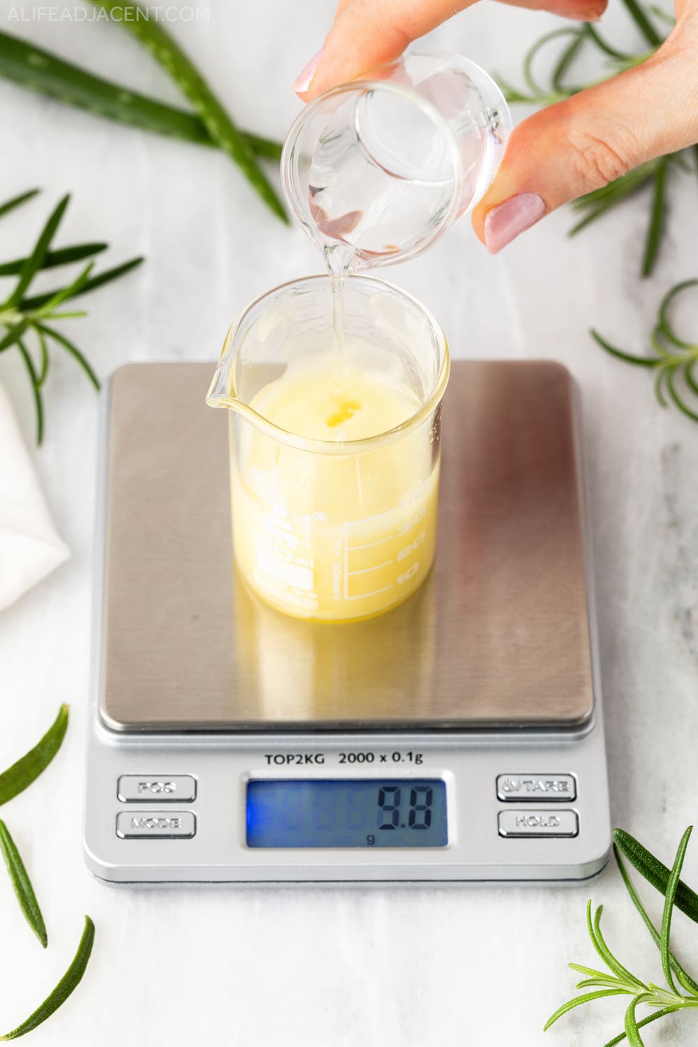 Pouring water into hair growth serum formula.