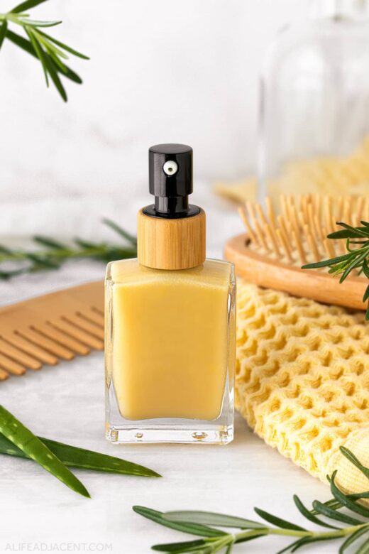 Rosemary hair serum in glass pump bottle.