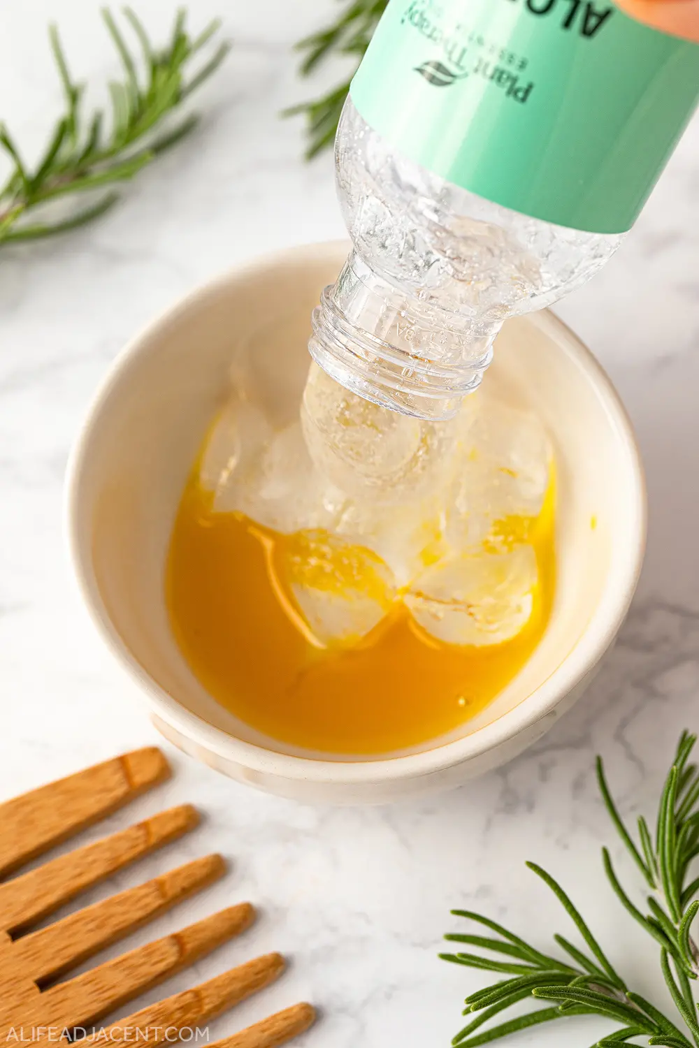 Adding aloe vera gel to lecithin and rosemary oil mixture.