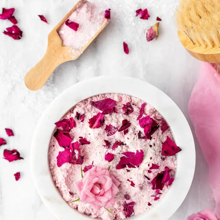 Rose bath soak recipe &ndash; in bowl with wooden bath scoop.