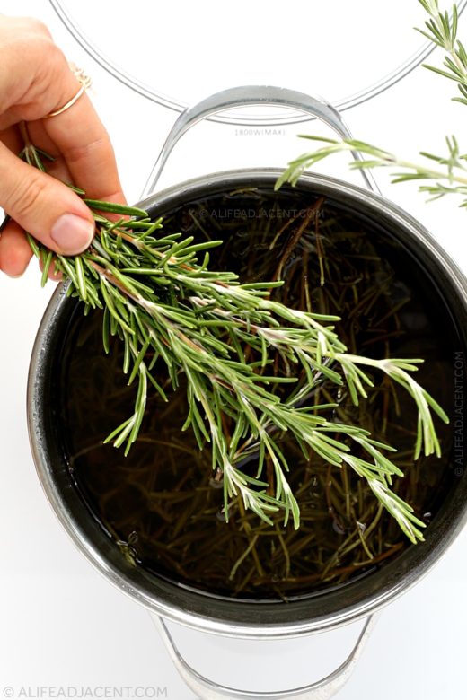 Making rosemary water for hair with fresh rosemary.