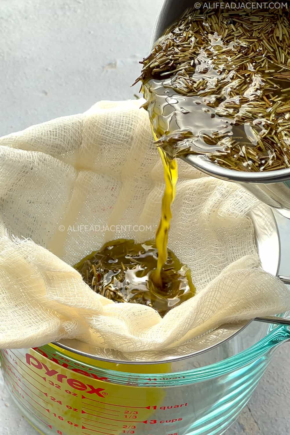 Straining rosemary leaves from homemade hair oil.