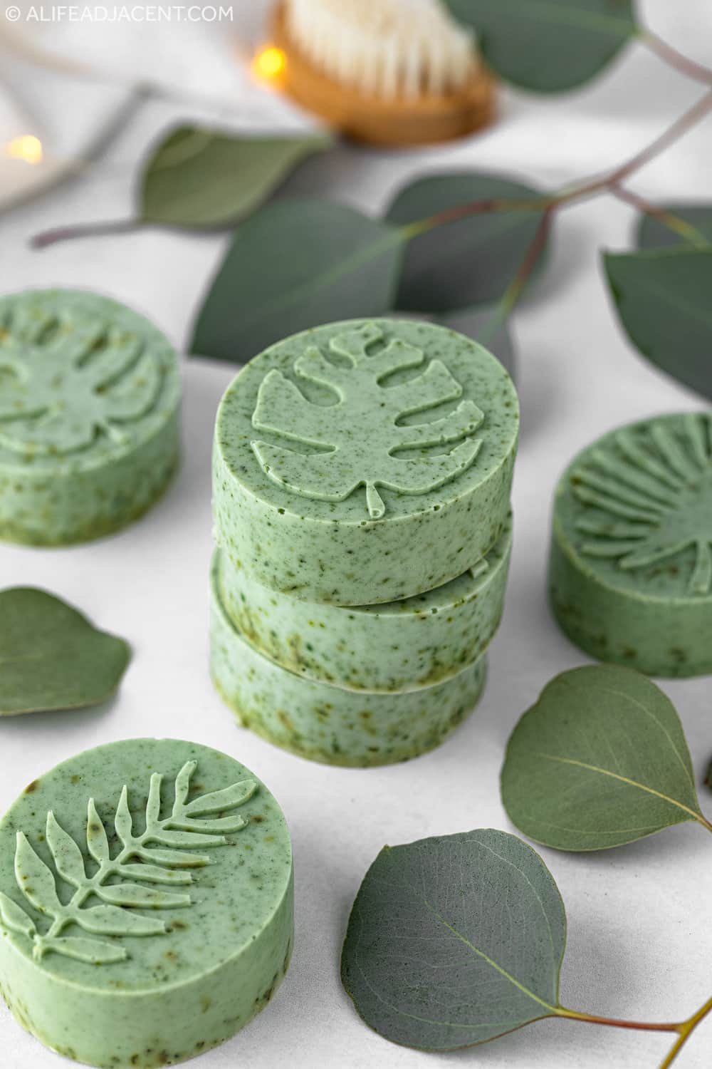 Stack of round eucalyptus soap bars made from melt and pour soap.