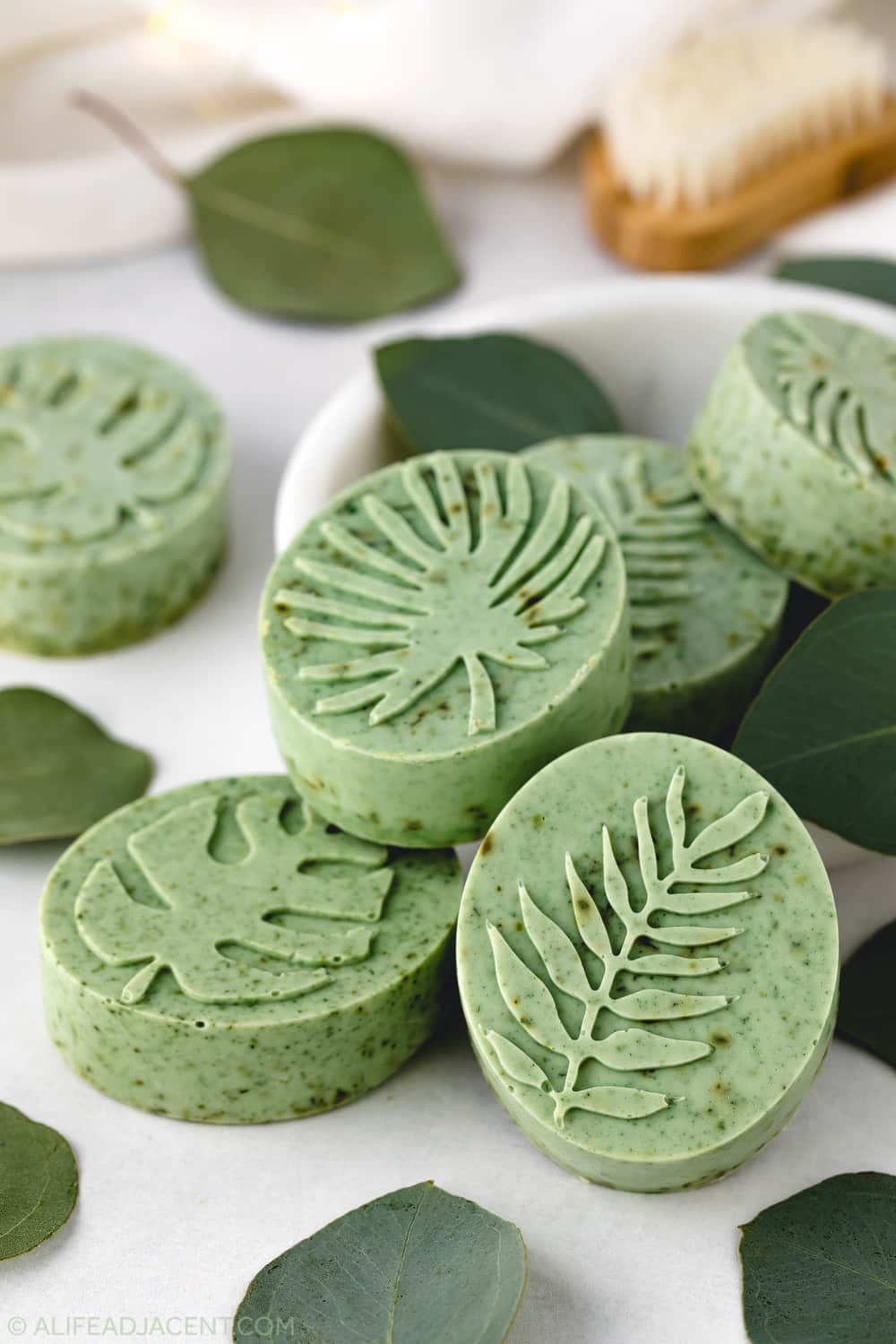 Eucalyptus soap with dried herbs and botanical leaf design.